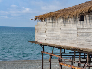 Cozy wooden beach hut overlooking the tranquil ocean