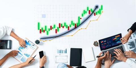 A diverse group of professionals engages in financial analysis, utilizing charts and graphs to evaluate market trends and foster strategic planning in a modern office environment. Axiom