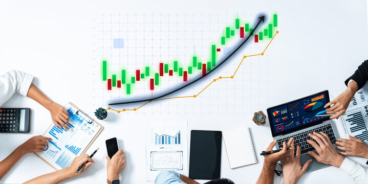 A diverse group of professionals engages in financial analysis, utilizing charts and graphs to evaluate market trends and foster strategic planning in a modern office environment. Axiom