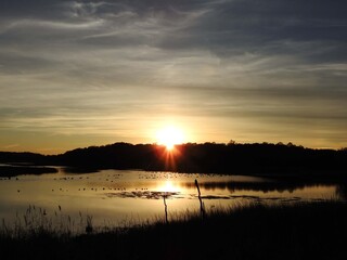 Obraz premium Tranquil scene, sunset over the wetlands of the Bombay Hook National Wildlife Refuge, Kent County, Delaware.