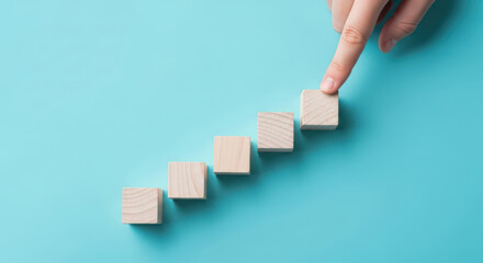 Finger Pushing Wooden Blocks in Ascending Row.