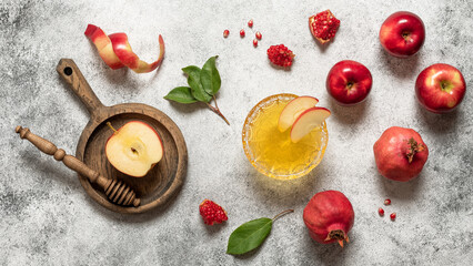 Apples, honey, and pomegranate on a rustic background, top view. Rosh Hashanah holiday.