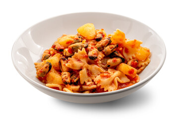 Bowtie pasta with mussels and potatoes in tomato sauce on a white plate isolated