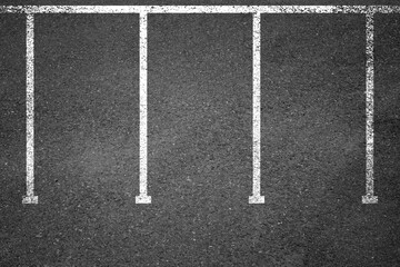 Fototapeta premium Top view of car park lots on city street or underground garage. Vector background of empty parking with white and yellow lines road marking on black asphalt surface