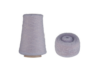 A Purple fluffy yarn set with a spool on a cardboard bobbin and a smaller ball, isolated on a white background. Ideal for knitting, crocheting, or craft projects, this fresh yarn adds a cool,