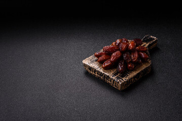 Dried dates in a ceramic plate, arabic food for the ramadan table. Dried dates as a background