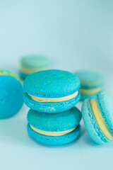 few of a blue colored macaroons on a flat blue background