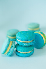 few of a blue colored macaroons on a flat blue background