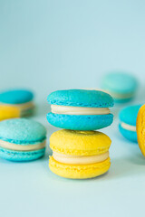 Blue and yellow macaroons on a solid blue background