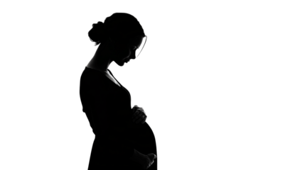 A pregnant woman is standing in front of a white background