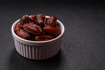 Dried dates in a ceramic plate, arabic food for the ramadan table. Dried dates as a food backgrounds