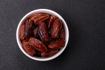 Dried dates in a ceramic plate, arabic food for the ramadan table. Dried dates as a food backgrounds