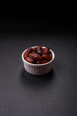 Dried dates in a ceramic plate, arabic food for the ramadan table. Dried dates as a food backgrounds