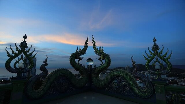 Video background of Chonburi city viewpoint. At the Samnaksong Khao Phra Khru viewpoint in the Sri Racha Thailand,a beautiful Naga statue and a white Buddha statue stand tall among the mountains.