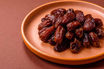 Dried dates in a ceramic plate, arabic food for the ramadan table. Dried dates as a food backgrounds