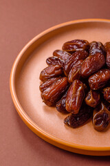 Dried dates in a ceramic plate, arabic food for the ramadan table. Dried dates as a food backgrounds