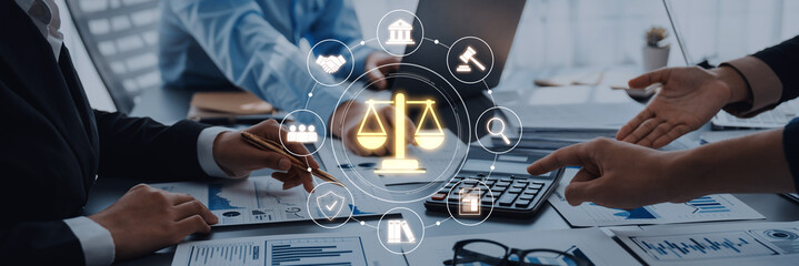 Professional team collaborates in a modern office discussing legal matters, featuring scales of...