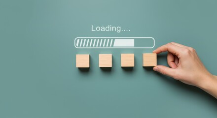 A hand placing a wooden block to complete a loading bar on a green background