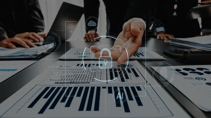 Diverse professionals engage in a business meeting, analyzing data charts and discussing security, enhanced by a digital overlay symbolizing protection and AI technology. Raster