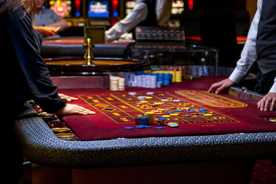 Close up of a Roulette Table. People play poker in the casino. Croupier behind gambling table in a casino