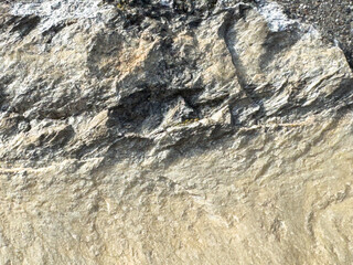 Rough textured rock surface with natural patterns and layers