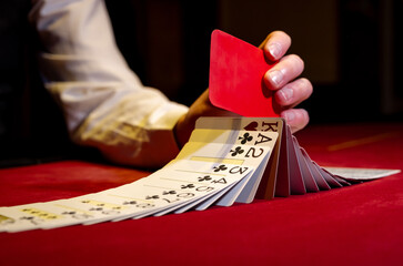 Croupier hands dealing cards on t blackjack poker table, gambling table with cards and chips. The...