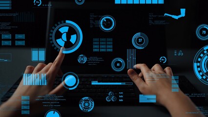 This image displays hands interacting with a futuristic laptop user interface, showcasing blue digital data graphics on a black screen, ideal for tech-related visuals. Xenic