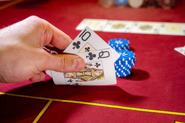The interior of the casino. Playing cards close-up at the poker table card combination hearts Royal...