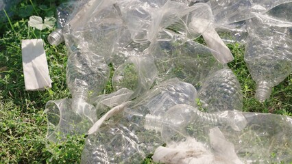 hand puts a plastic bottle in a bag, garbage for processing, eco, keep the environment clean, green planet safe, nature forest ecosystem, environmental protection problem, charitable activities.