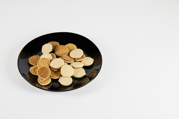 Homemade cookies topped with meringue frosting, freshly baked on a white background with copy space