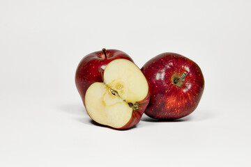 Group of red apples on a table in close-up with copy space under a white background