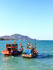 Obraz premium Beautiful fishing boat and Squid fishing boat prepare to go to ocean, south east asia sea.