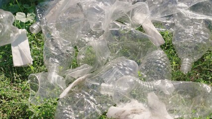 hand puts a plastic bottle in a bag, garbage for processing, eco, keep the environment clean, green planet safe, nature forest ecosystem, environmental protection problem, charitable activities.