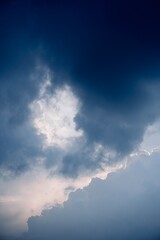 Moody sky with dark clouds and glowing light opening