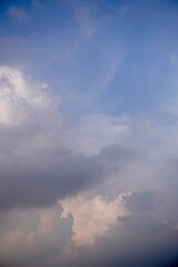 Pastel toned clouds floating in soft daylight sky