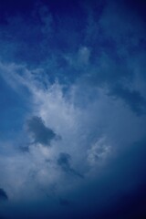 Dark evening sky with soft glowing cloud textures