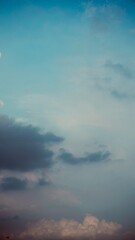 Contrasting dark and bright clouds under turquoise sky