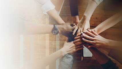 Hands joined over wooden table