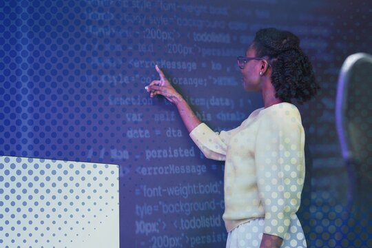 Woman analysing binary code on virtual screen