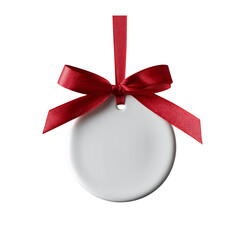 v a round, white ceramic ornament with a red ribbon bow hanging on the left side, isolated on a...