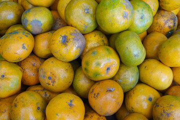 piles of local citrus fruit, fruit that contains lots of sweet and fresh juice rich in vitamin C, looks bright in color even though it is not as smooth as other imported                               