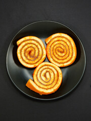 Sweet cakes on plate closeup view on black background, Flat lay food photography concept 