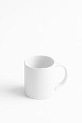 Obraz premium Hyper-realistic image of a white mug on a white background in a minimalist design for branding with copy space.
