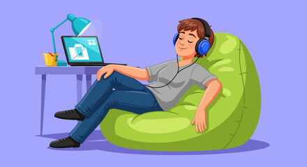 Young person relaxing with headphones and laptop on beanbag