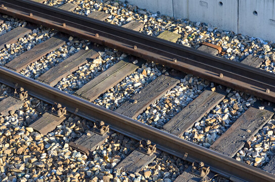 Close-up view of railway tracks with wooden sleepers and gravel ballast