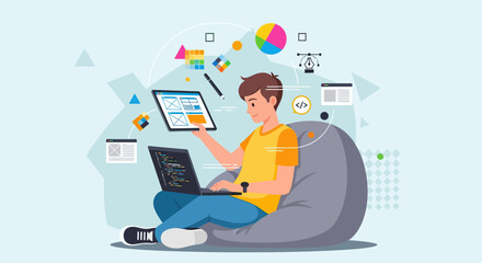 Smiling young man coding and designing UI/UX on laptop and tablet, sitting comfortably on bean bag