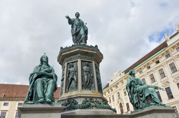 Close view of Francis I monument at Hofburg Palace with detailed bronze statues and cloudy sky in Vienna, Austria.