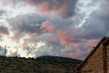 Pink clouds over the village of Mora de Rubielos at sunset, Teruel, Aragon, Spain