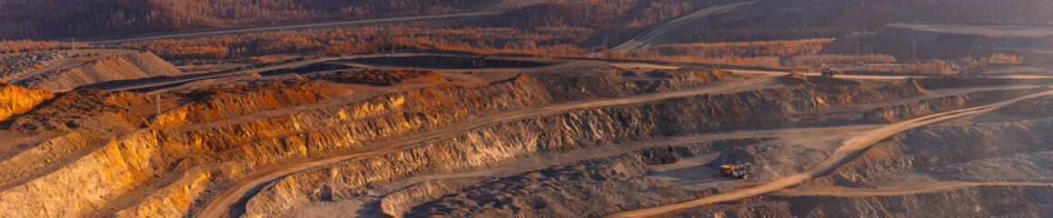 Aerial View panorama of expansive industry Open Pit Mine of ore, industrial Sunset Landscape