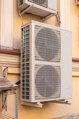 industrial C air conditioner is installed on the facade of a house or office. ventilation and cooling system, air purification technology. split system. cooling in hot weather. climate.